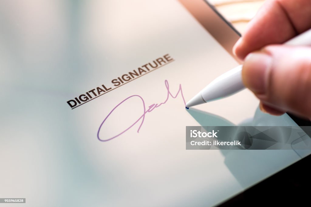 Digital Signature Concept with Tablet and Stylus Pen Signature Stock Photo