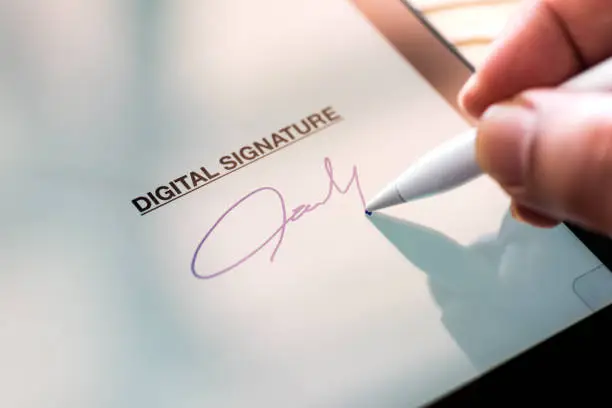 Photo of Digital Signature Concept with Tablet and Stylus Pen