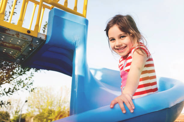 istock Little Girl Playing At Playground Outdoors In Summer 955966396