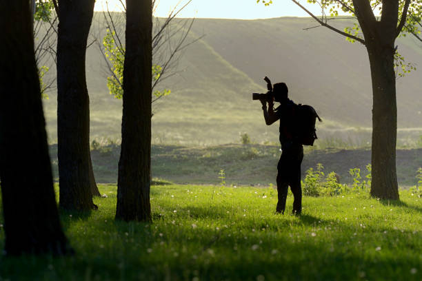 istock Silhouette of photographer in nature 955967110