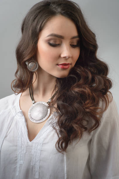 istock Beautiful young girl with luxurious silver ornaments 955972106