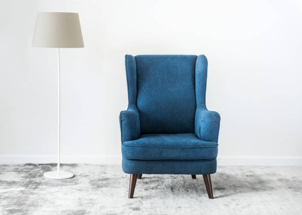 istock Wing back chair on a carpet no people 955973256