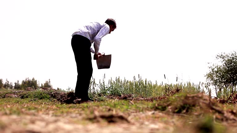 Using A Digging Hoe 850+ Farmer Digging In His Field Using Hoe Stock Videos and Royalty ...