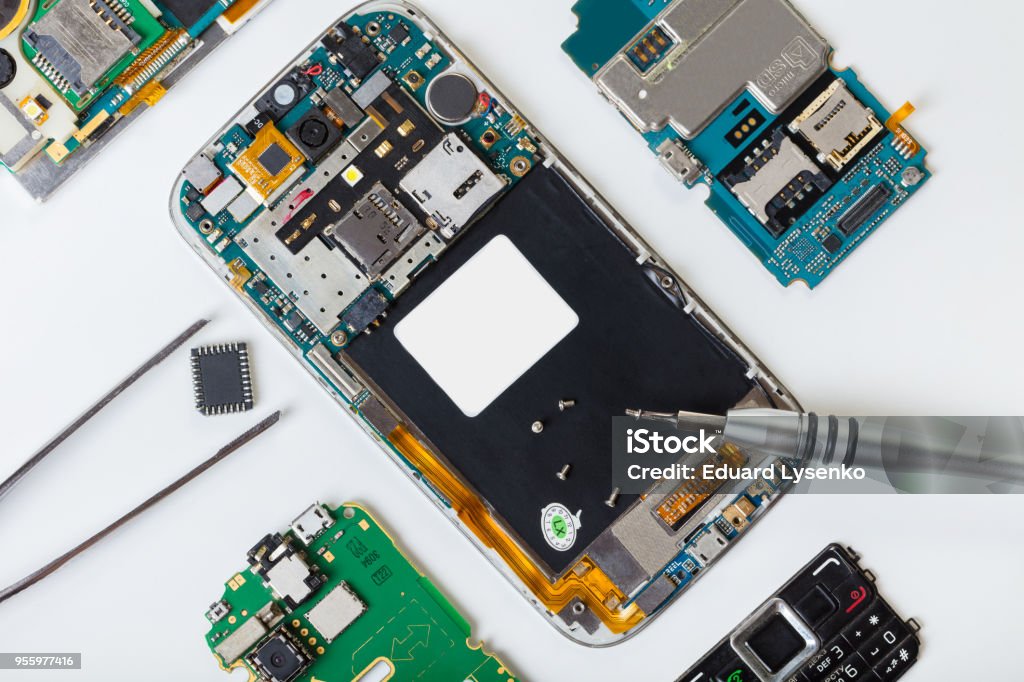 disassembled mobile phone and tools disassembled mobile phone and tools on white background Repairing Stock Photo
