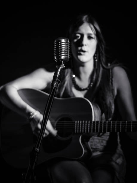 istock Blurred guitarist behind vintage microphone 955977780