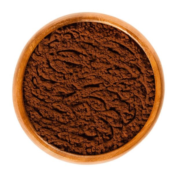 istock Fine cocoa powder in wooden bowl over white 955980552