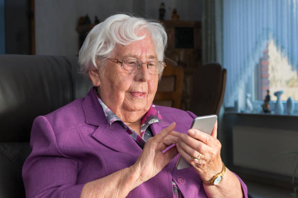 istock Old woman uses a smartphone 955982916