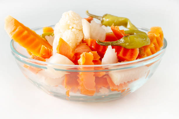 Assorted pickles vegetables carrot, chilli, cauliflower in glass bowl. Top view. Isolated. Copy space.