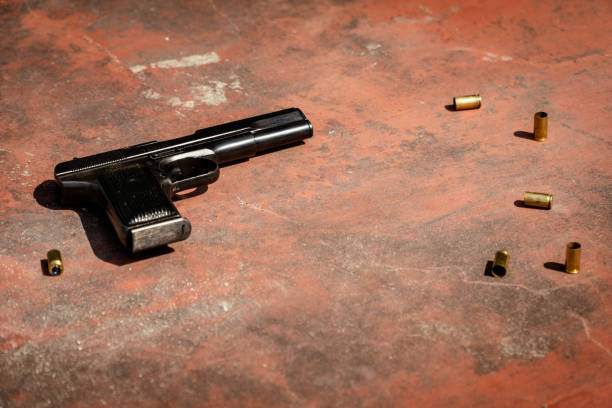 istock handgun on the concrete red backgroound 955984798