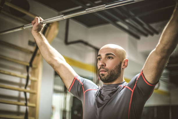 istock Young men exercise at the gym. Close up image. 955984964