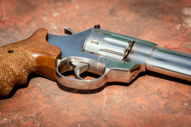 istock handgun on the concrete red backgroound 955985010