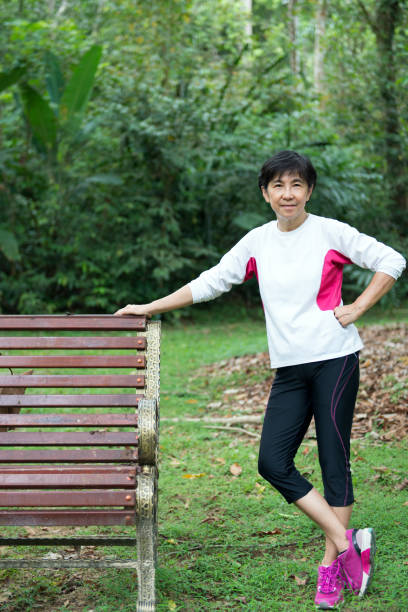 Senior woman relaxing on park bench