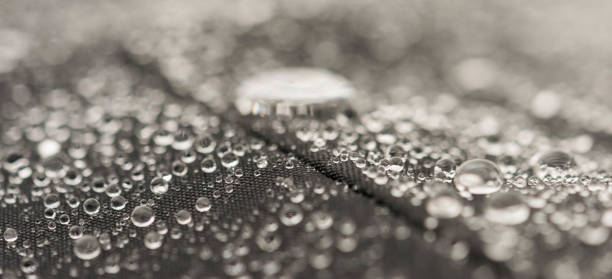 istock Closeup detailed view of raindrops on a fabric, a background. 955989182