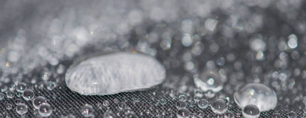 Closeup detailed view of raindrops on a fabric, a background.