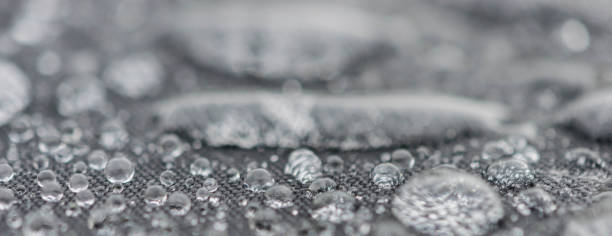 istock Closeup detailed view of raindrops on a fabric, a background. 955990208