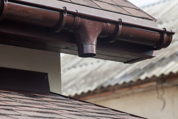 istock Roof under construction with new asphalt tile and rain gutter 955990608