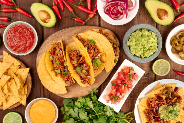 Overhead photo of assortment of Mexican tapas An overhead photo of an ssortment of many different Mexican tapas, including tacos, guacamole, pico de gallo, nachos and others mexican food stock pictures, royalty-free photos & images