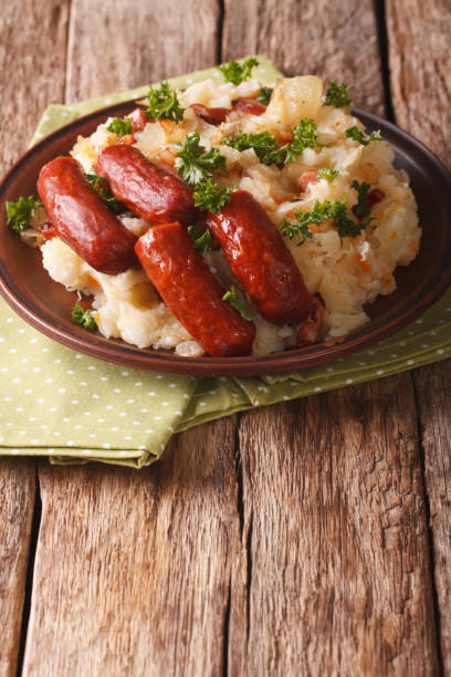 istock stamppot mashed potatoes, cabbage and carrots, with sausages close-up. vertical 955994330
