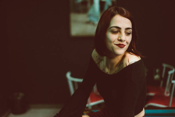 istock Beautiful tattooed woman playing billiards 955995040