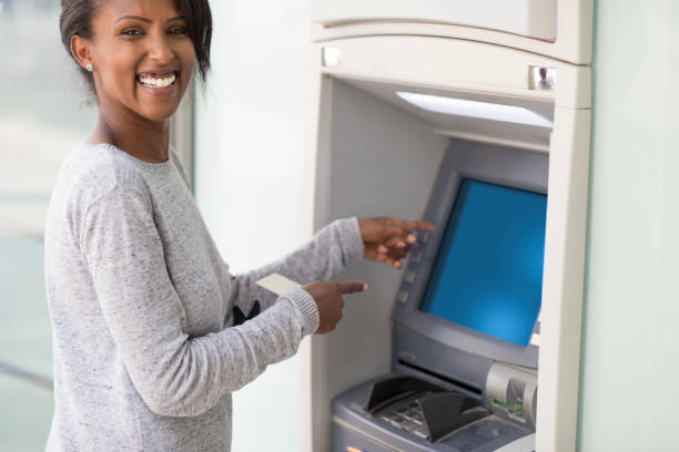 istock Woman showing, pointing on blank ATM machine's blue screen. 955998148