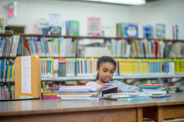 istock Girl With Stacks Of Books 955998170