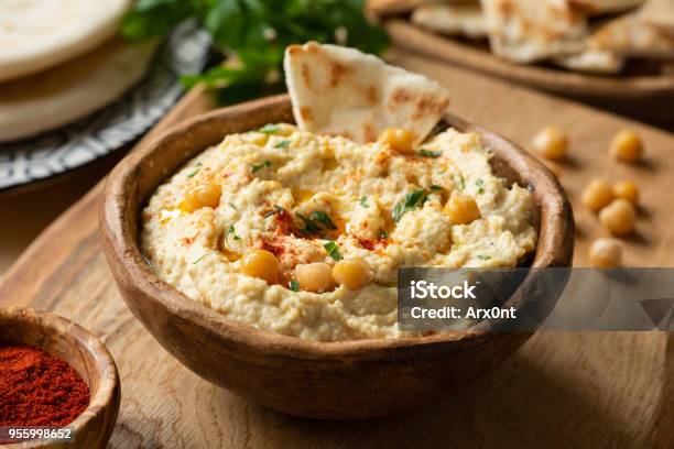 Homemade Chickpea Hummus Bowl With Pita Chips And Paprika Stock Photo - Download Image Now