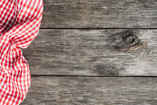 istock Red plaid kitchen textile on old wooden background 955998698