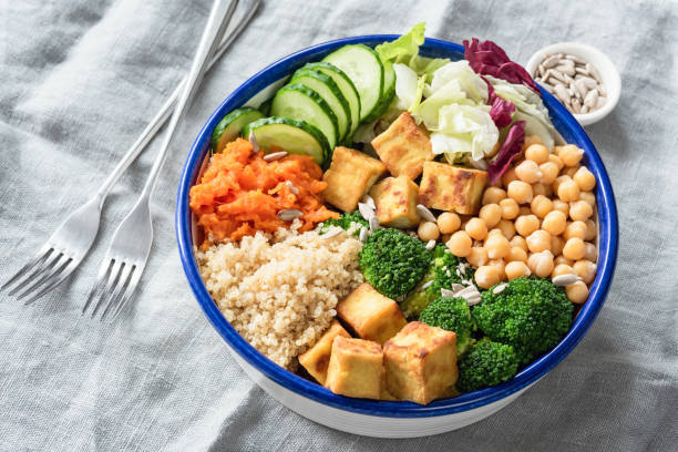 Nourishing buddha bowl with tofu, quinoa and vegetables Nourishing buddha bowl with tofu, quinoa and vegetables. Healthy eating, healthy lifestyle, vegan food, vegetarian diet, modern lifestyle concept. Colorful buddha bowl on table. Selective focus tofu photos stock pictures, royalty-free photos & images