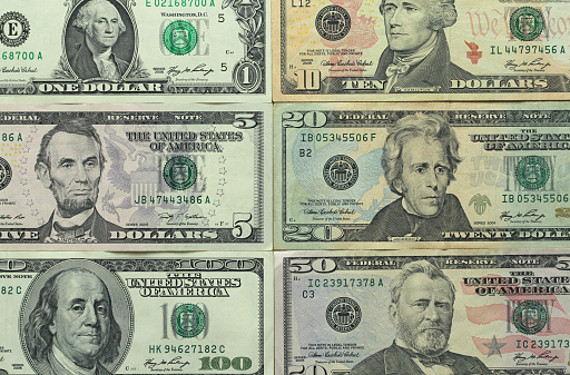 Paper dollars of different denominations - 1, 5, 10, 20, 50 and 100 dollars. Background of dollars.