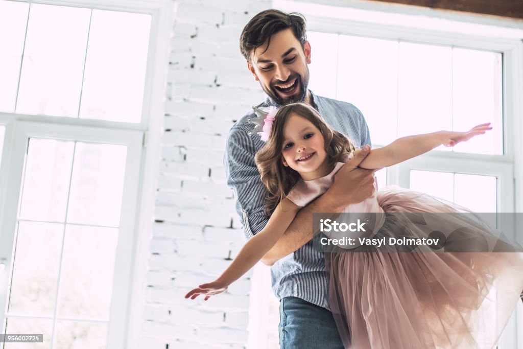 Dad with daughter at home I love you, dad! Handsome young man is dancing at home with his little cute girl. Happy Father's Day! Father Stock Photo