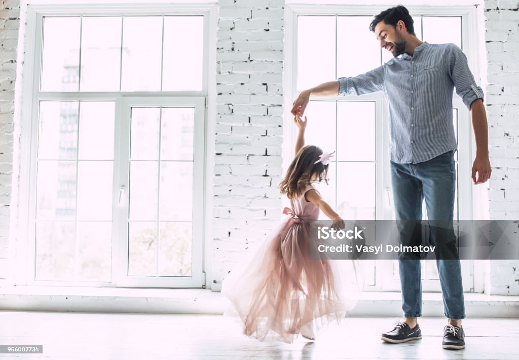 Dad with daughter at home I love you, dad! Handsome young man is dancing at home with his little cute girl. Happy Father's Day! Father Stock Photo