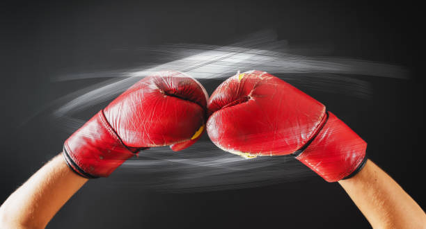 istock Old Red Boxing Gloves Glow Flashes Dark Background 956003420