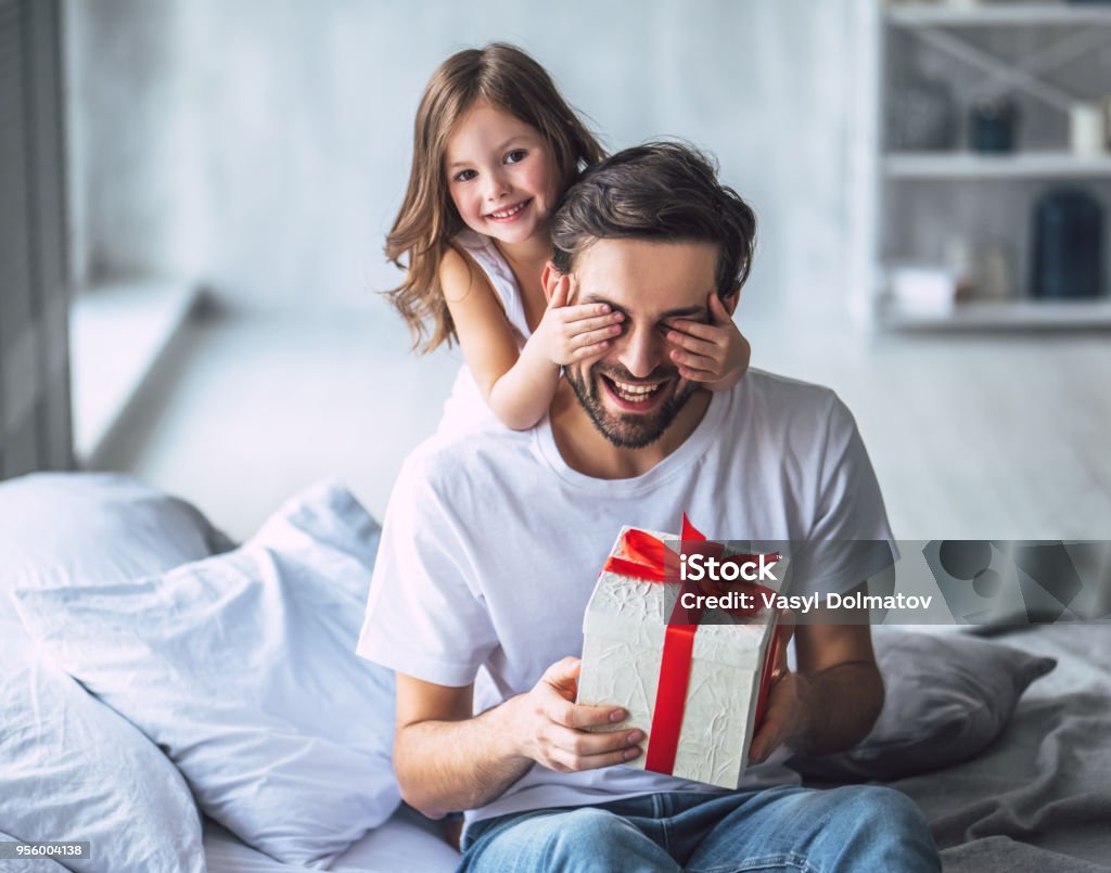 Dad with daughter at home I love you, dad! Handsome young man at home with his little cute girl. Happy Father's Day! Father's Day Stock Photo