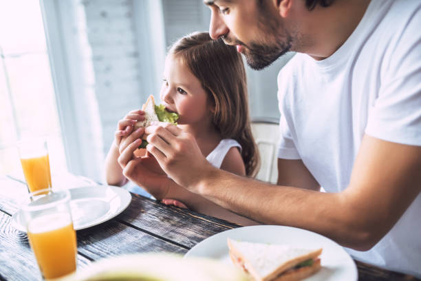 istock Dad with daughter at home 956005060