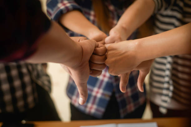 istock business group showing joins thumb down for fail business. 956005504
