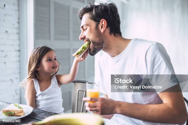 Dad With Daughter At Home Stock Photo - Download Image Now - Eating, Family, Father