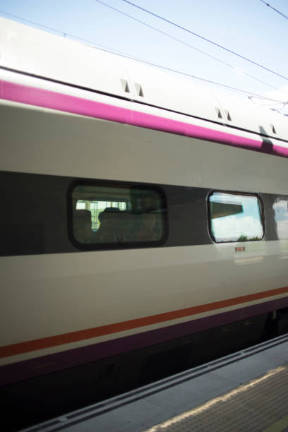 istock High speed modern bullet passenger train in station by platform in Spain. 956012550