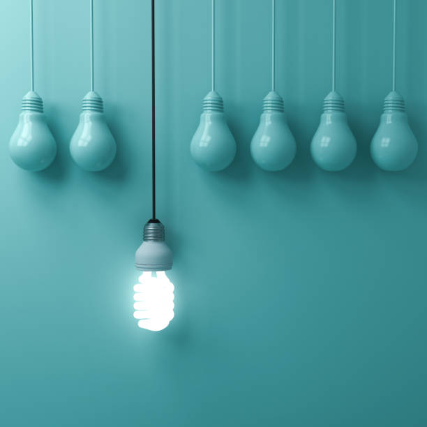 istock One hanging eco energy saving light bulb glowing and standing out from unlit incandescent bulbs on green pastel wall background , leadership and different creative idea concepts . 3D rendering 956014612
