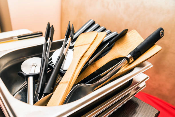 istock Wooden and plastic kitchen tools lie in tray 956016868