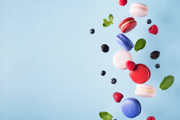 istock Macaroons, raspberries, blackberries and blueberries flying 956017182