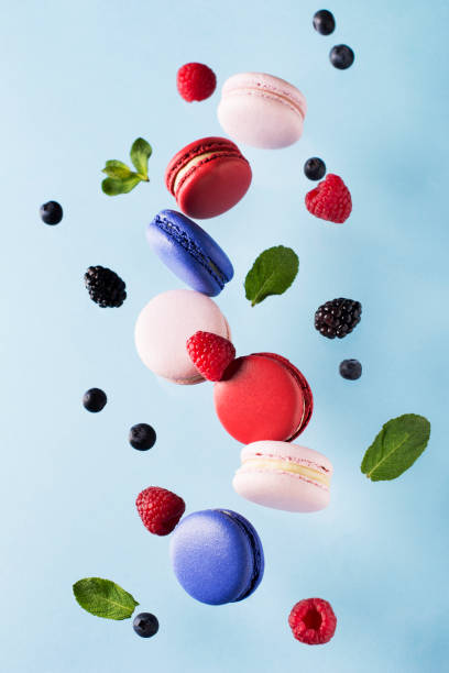 Macaroons, raspberries, blackberries and blueberries flying