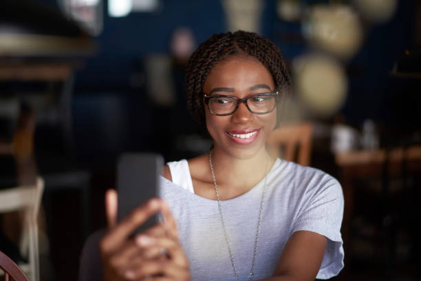 istock Black woman with mobile phone 956017282