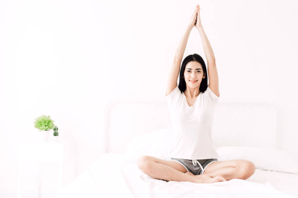 istock Woman practicing yoga at home in bedroom 956026646