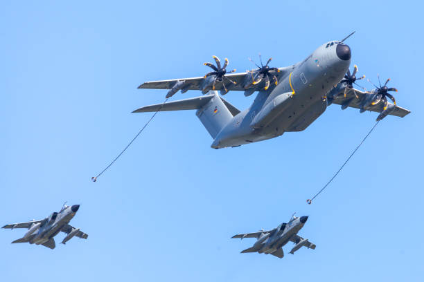 軍事のエアバス a 400 m 輸送機は飛行場・ シェーネ フェルトで 2 つ panavia のトルネードのマルチロール戦闘航空機で飛ぶ/ベルリン。 - airshow airplane weather military ストックフォトと画像