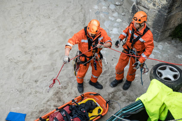 Firefighters in a rescue operation of car accident; all logos removed. Slovenia, Europe. Nikon.