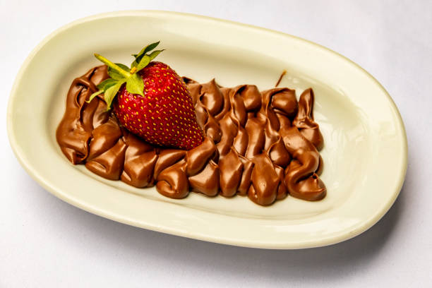 istock strawberries and chocolates in white ceramic plates 956030818