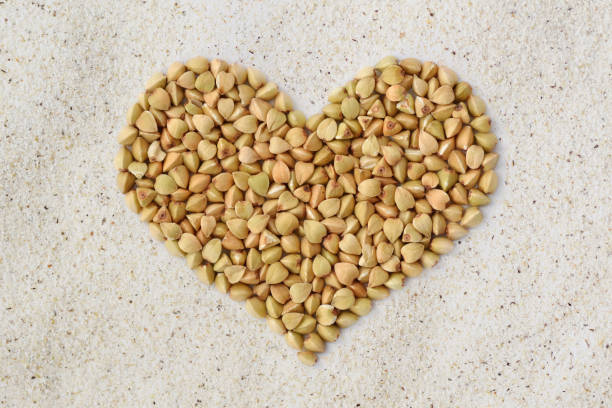 istock Buckwheat kernels heart on buckwheat flour background 956032114