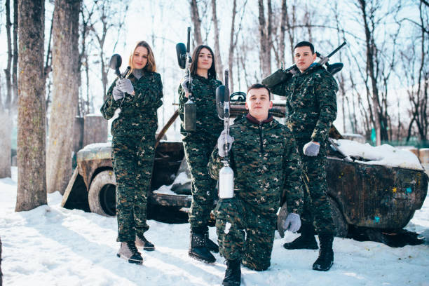 istock Paintball team poses with marker guns 956032650