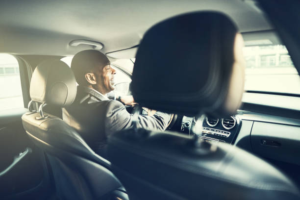 istock African businessman laughing while driving through the city 956035132