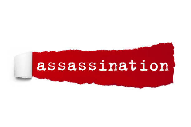 istock Word assassination written under the curled piece of Red torn paper. Concept Image 956035496